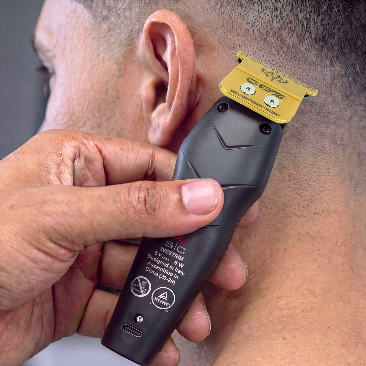 Barber lining a neckline with the StyleCraft 3Versince trimmer