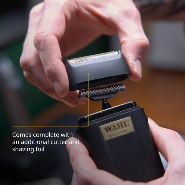 Close-up of the Wahl Micro Power shaver being fitted with its bonus replacement cutter and foil—underscoring hassle-free maintenance and extended tool life for professional barbers.