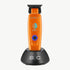 StyleCraft Saber SC421O cordless trimmer in orange on charging stand