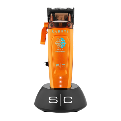 StyleCraft Saber 2 SC617O cordless clipper in orange on charging stand