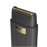 Angled close-up of the Wahl Micro Power single-foil shaver highlighting the gold perforated foil head, black housing, and gold logo, isolated on a transparent background.