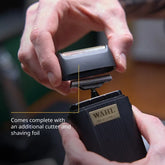 Close-up of the Wahl Micro Power shaver being fitted with its bonus replacement cutter and foil—underscoring hassle-free maintenance and extended tool life for professional barbers.